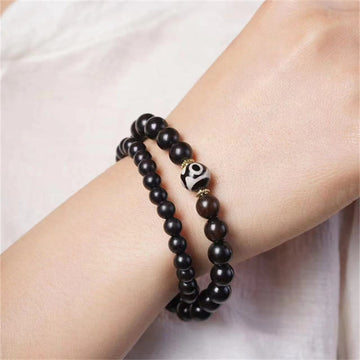 Pulsera Tibetana de Madera Ébano con Cuenta Dzi – Doble Vuelta