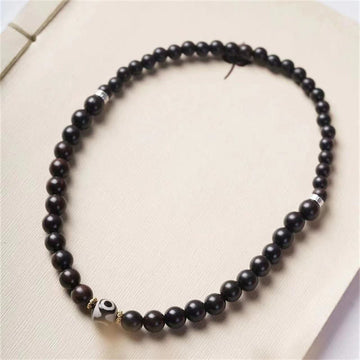 Pulsera Tibetana de Madera Ébano con Cuenta Dzi – Doble Vuelta