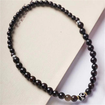 Pulsera Tibetana de Madera Ébano con Cuenta Dzi – Doble Vuelta